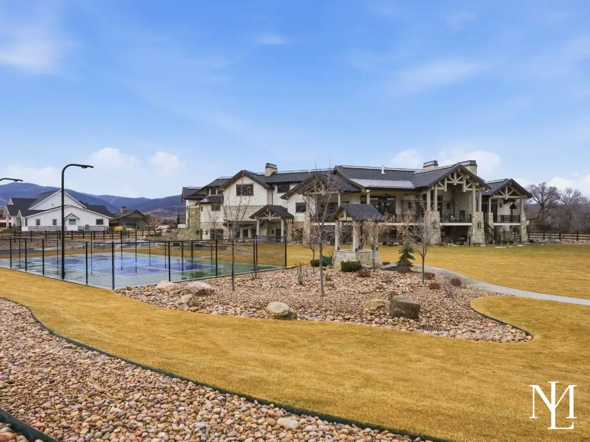Luxury Huntsville estate with private sport court, expansive lawn, and mountain backdrop in Ogden Valley.