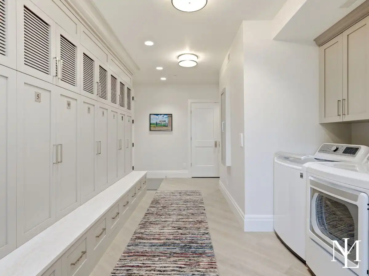 Oversized laundry and mudroom with custom lockers, bench seating, and built-in storage in luxury Huntsville home.
