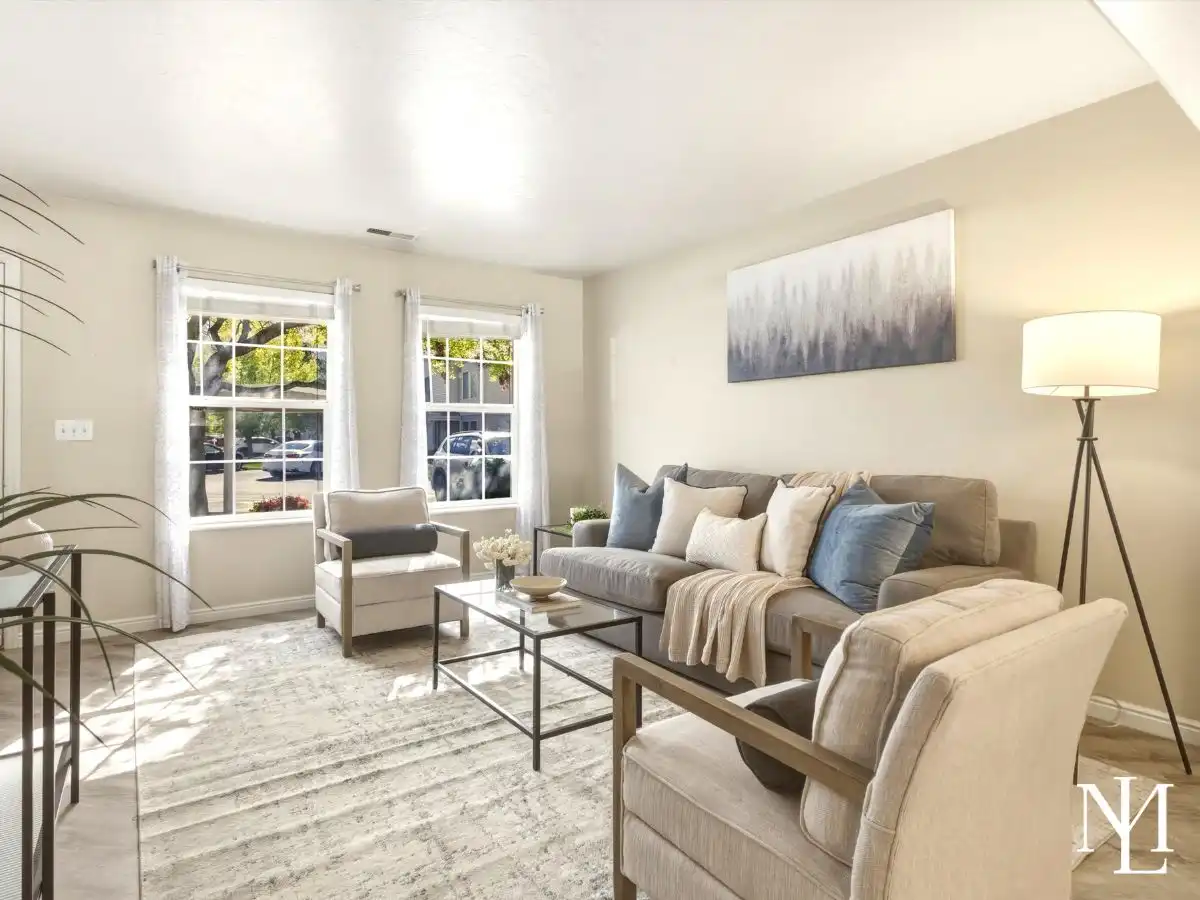 Bright living room in Draper townhome with large windows, neutral finishes, and natural light near South Mountain recreation