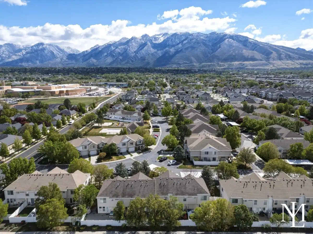 Aerial view of Draper neighborhood with townhomes, Wasatch Mountain views, and close proximity to South Valley recreation