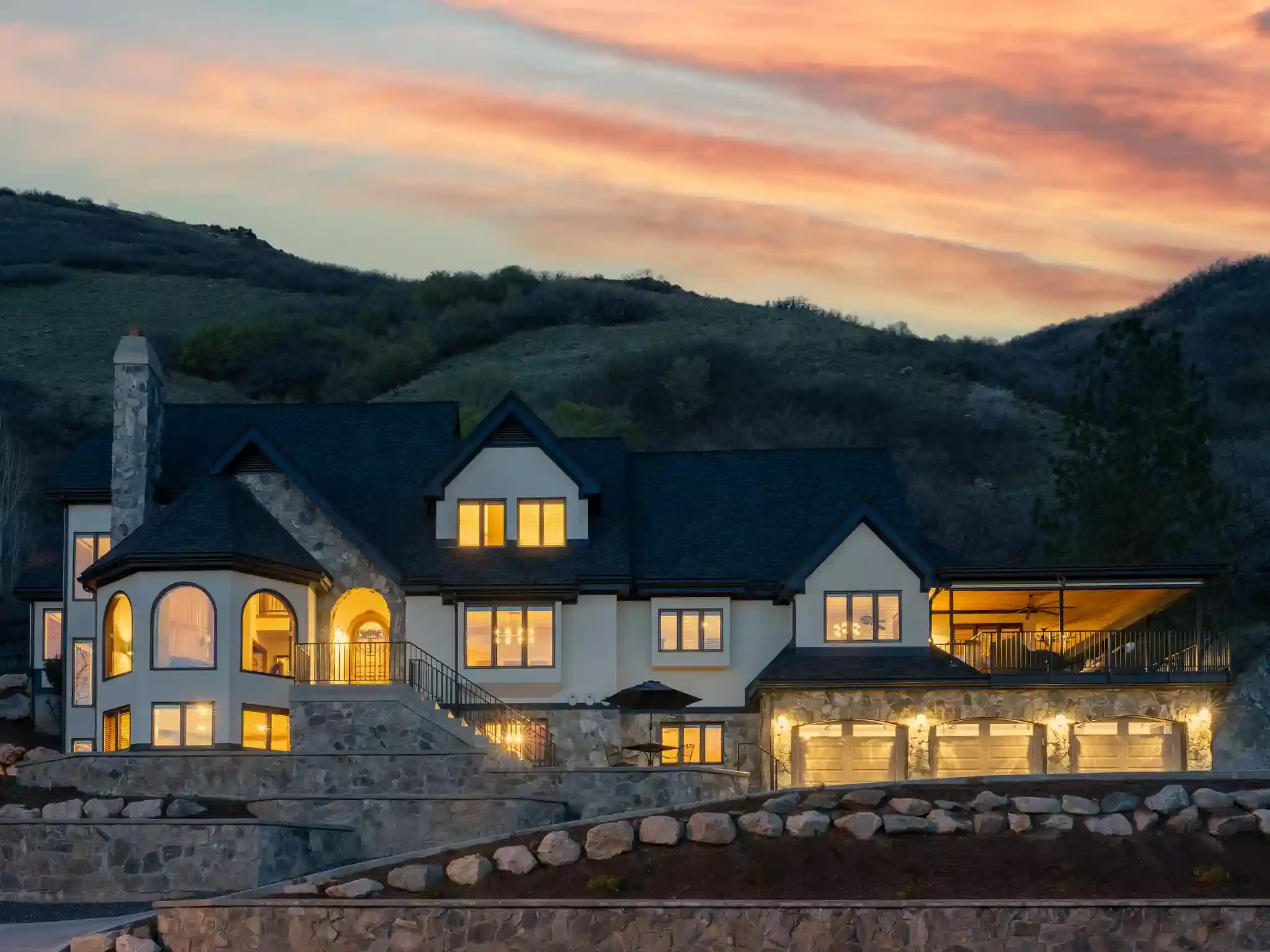 A beautiful twilight image of 4120 Beus Dr Ogden, UT lit up like a mountain chateau.