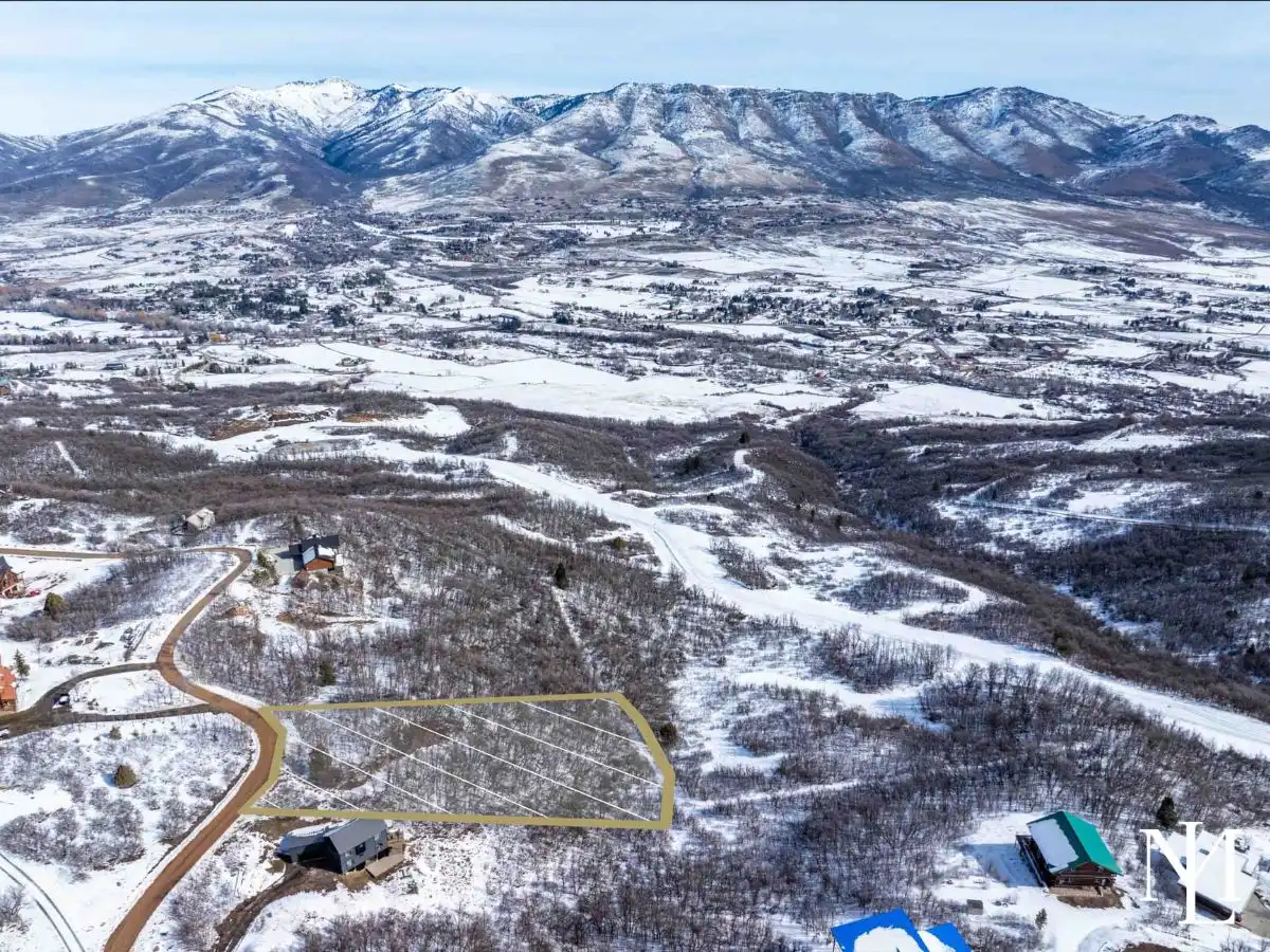 Aerial view of Eden Utah land for sale with outlined homesite, snow-covered Ogden Valley, and mountain views