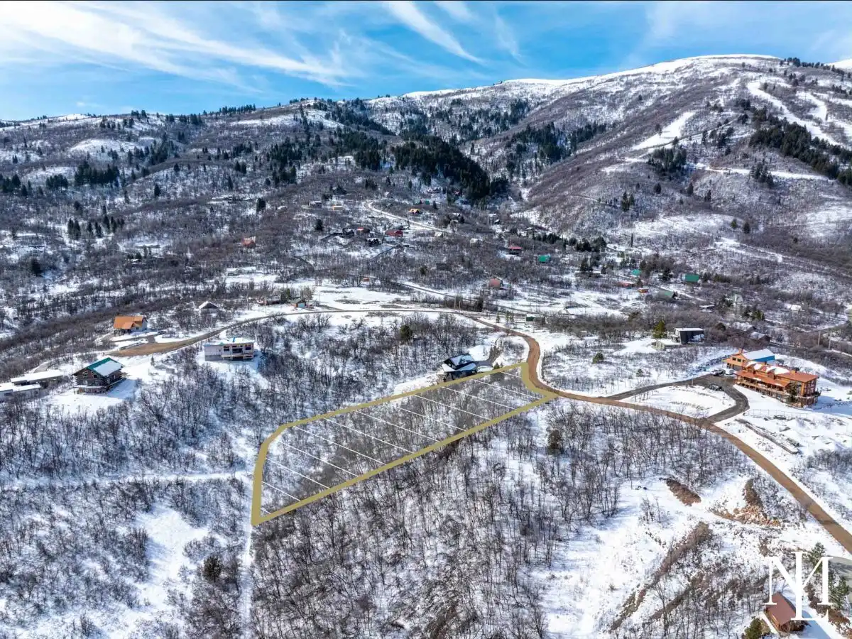 Wooded mountain lot outlined in Eden Utah near Nordic Valley Ski Resort with surrounding homes and snowy hillside terrain