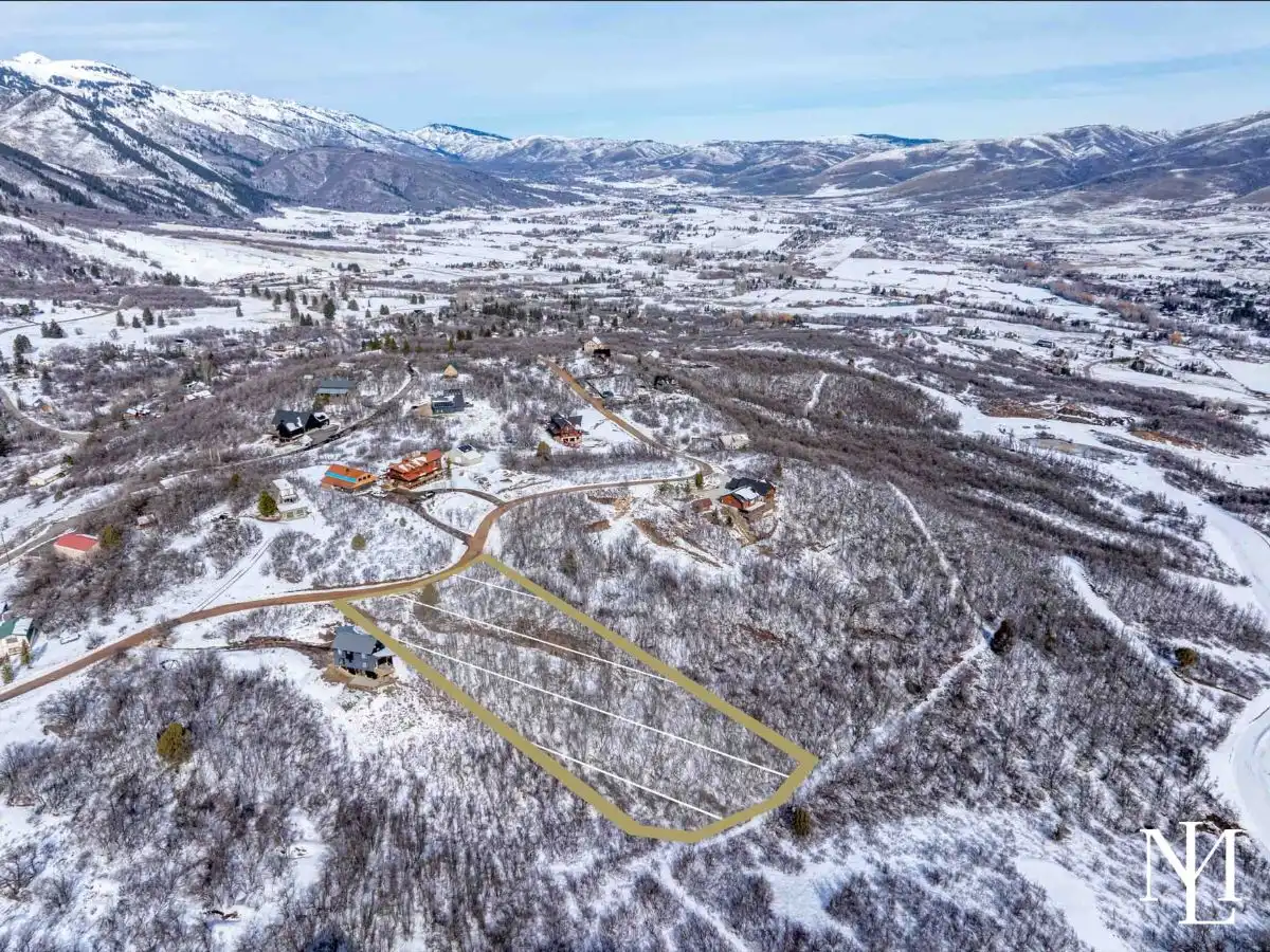 Aerial view of wooded lot in Eden Utah with panoramic Ogden Valley, mountain, and Pineview Reservoir views