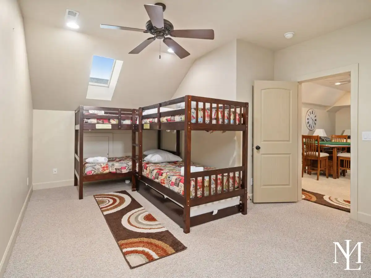 Bunk room in furnished Ogden Valley home with two bunk beds, skylight, and flexible sleeping space for guests