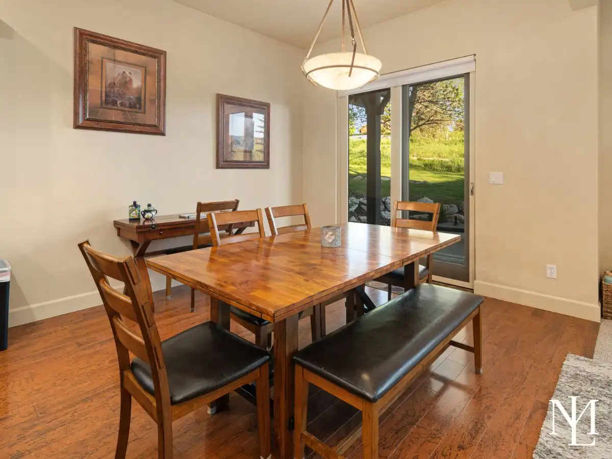 Dining area in furnished Eden mountain home with hardwood floors, sliding glass door, and access to outdoor patio