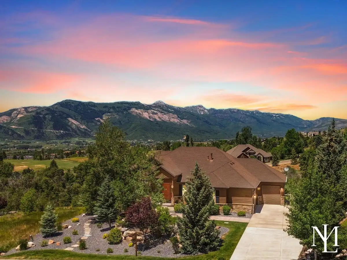 Custom Elkhorn hillside home in Eden Utah with panoramic Ogden Valley mountain views and sunset sky