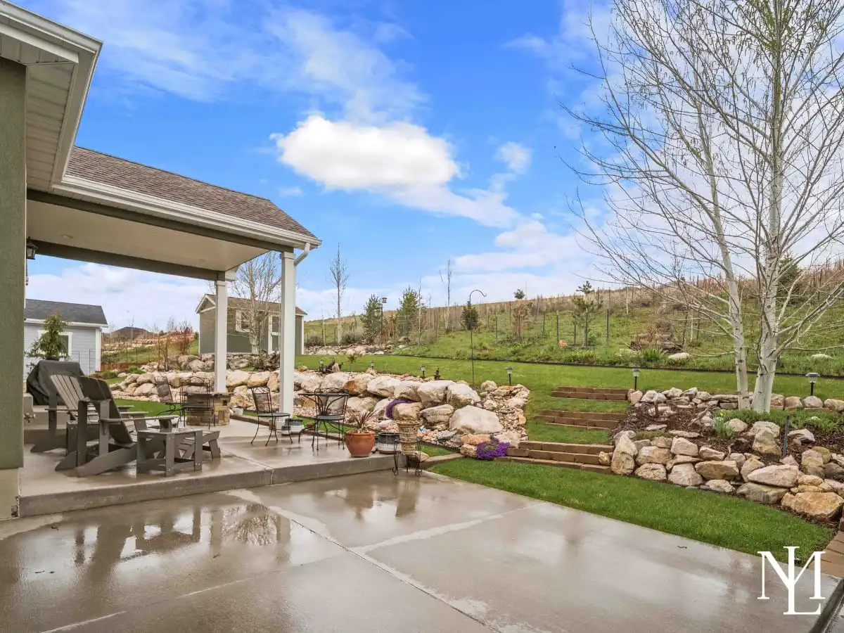 Covered patio and terraced backyard with landscaping in The Preserve at Sheep Creek.