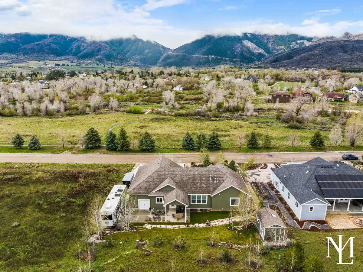 Aerial rear view of Eden, Utah home backing to open space with Ogden Valley mountain backdrop.