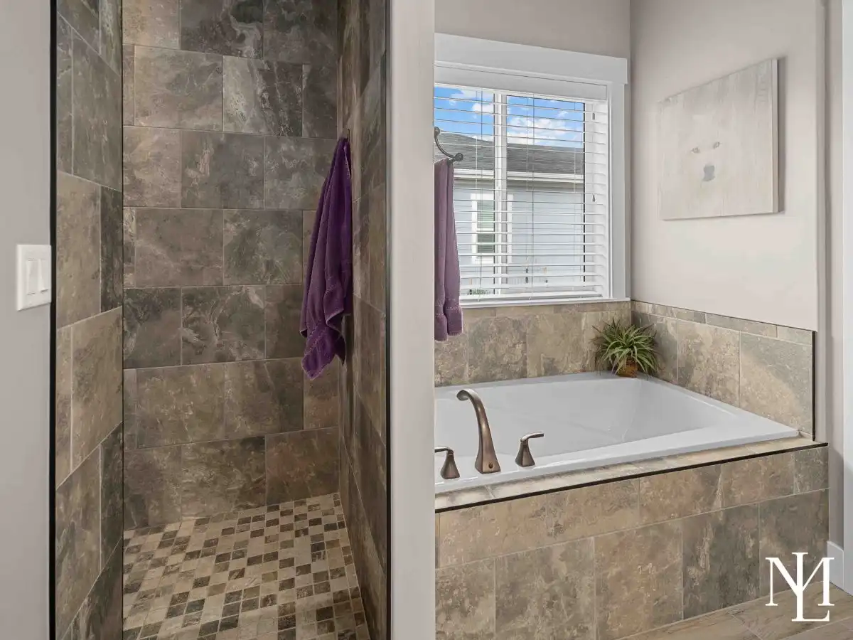 Primary bathroom with walk-in tile shower and soaking tub in Eden, Utah rambler.
