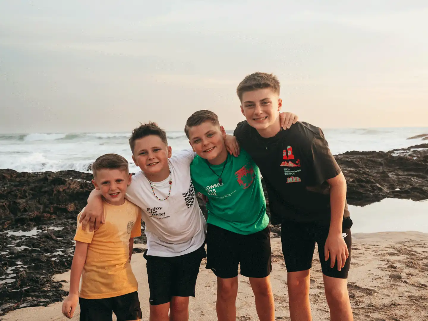 Four boys on the beach.