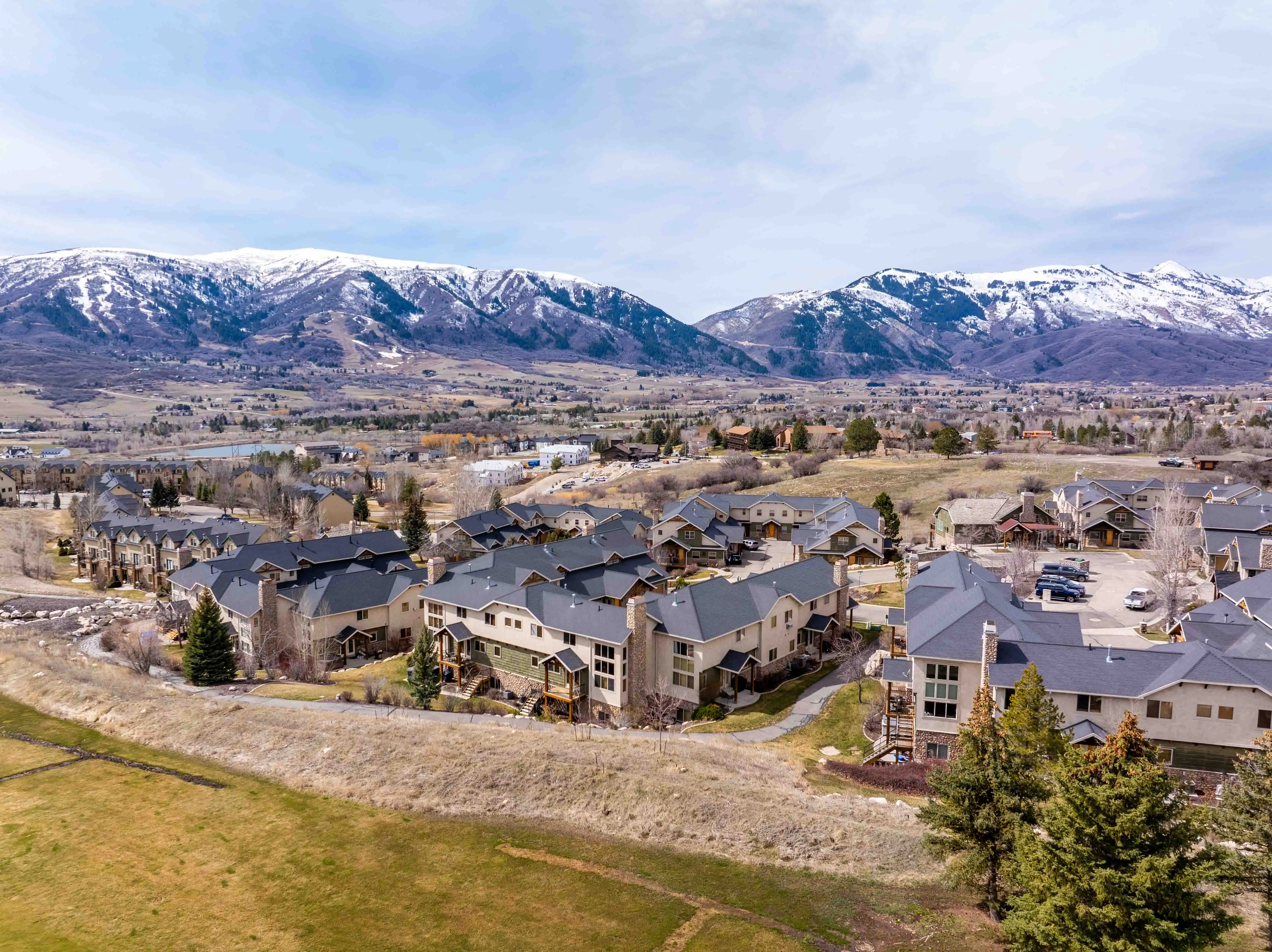 Aerial view of The Cascades at 5184 E Fairview Loop in Eden, Utah, with Ogden Valley and snowcapped Wasatch mountains.