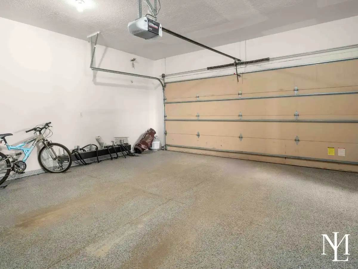 Clean epoxy-floor garage with LiftMaster opener, bike storage, and space for outdoor gear at Eden, Utah townhome.