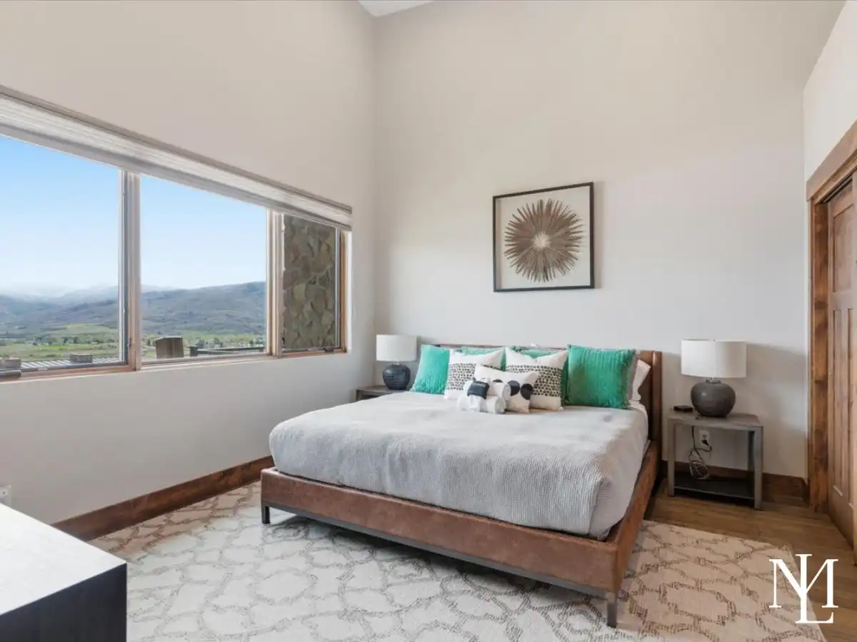 Primary bedroom with large picture window and Ogden Valley mountain views