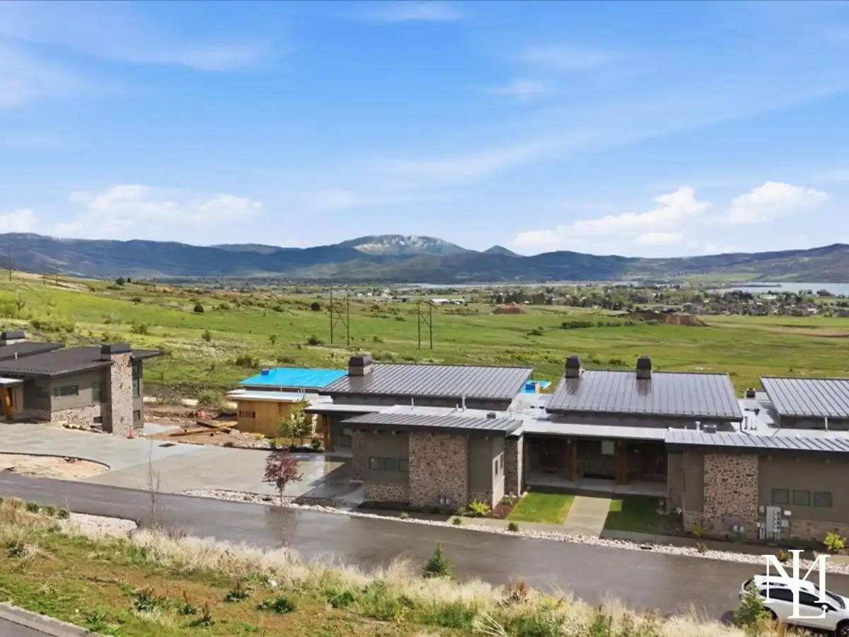 Aerial-style view of Eden, Utah townhomes with Ogden Valley and Pineview Reservoir in the distance.