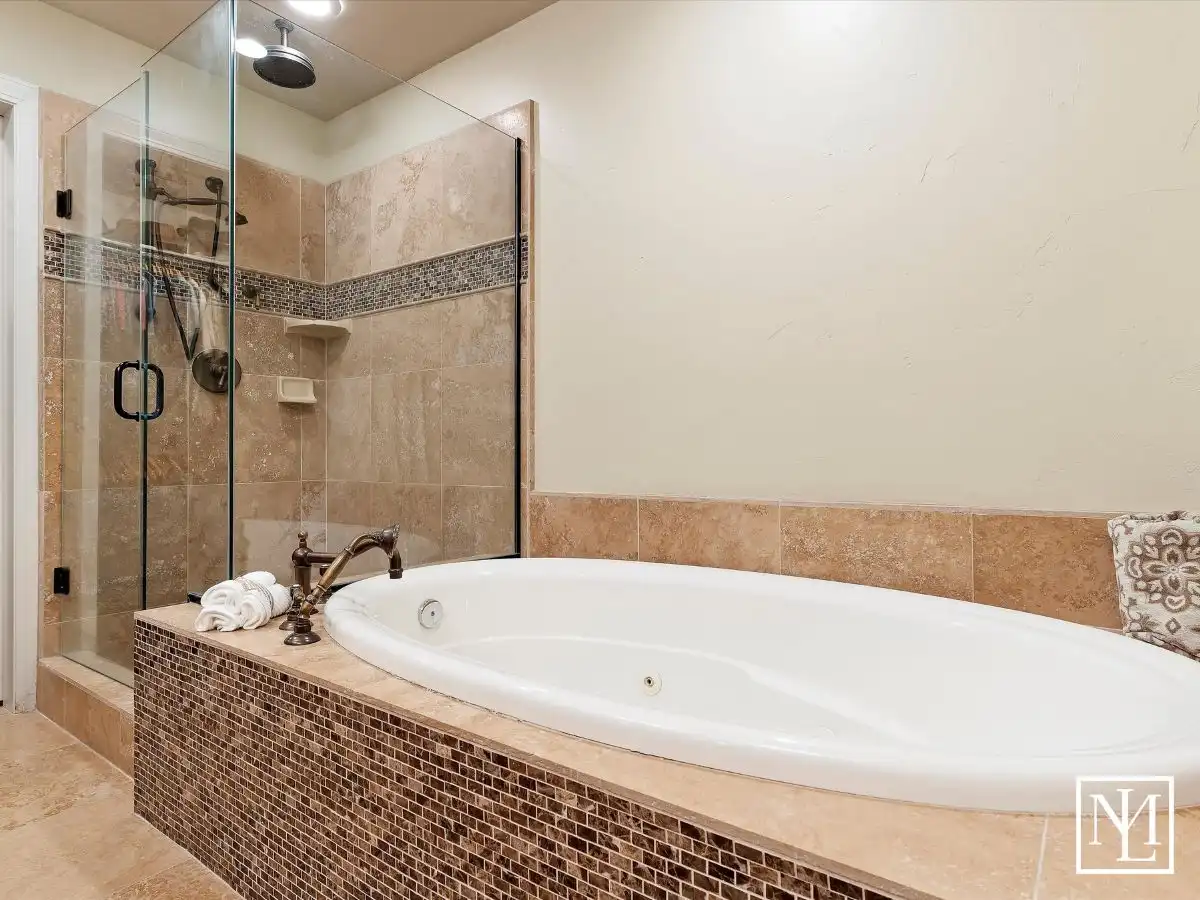 Spa-like primary bath with large soaking tub and walk-in tiled shower in the home at 5932 E Big Horn Pkwy
