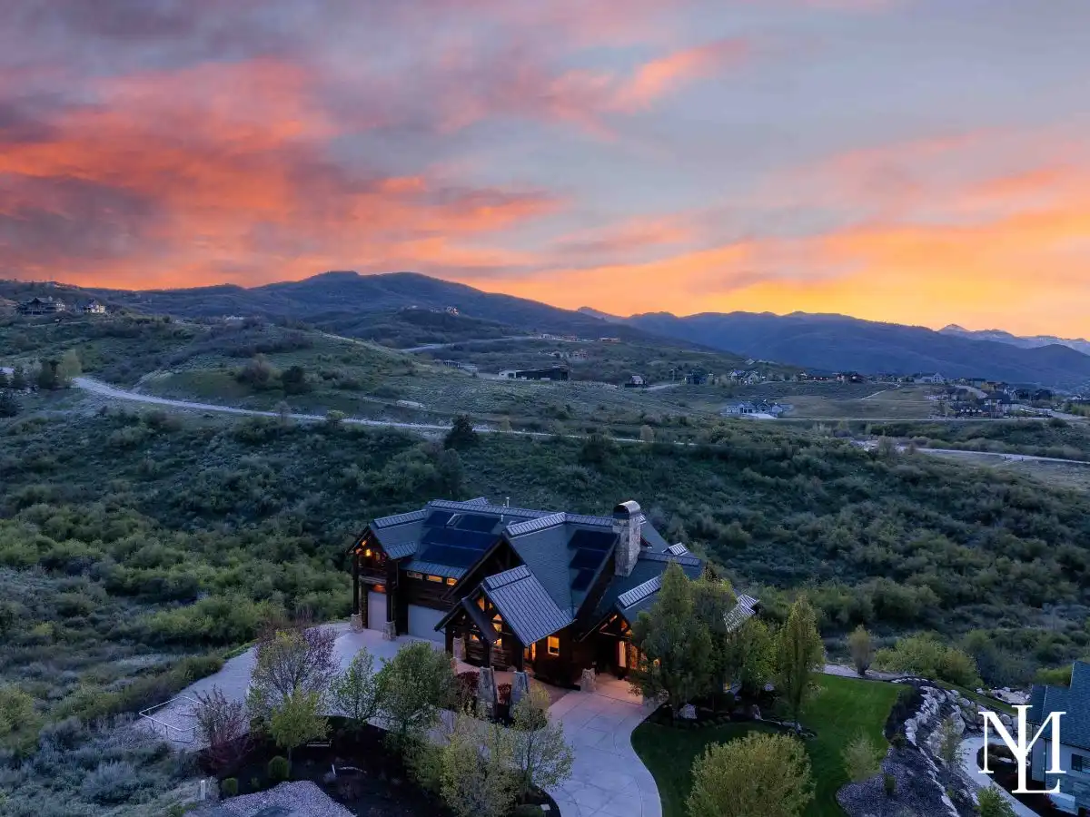 Aerial twilight view of custom Huntsville, Utah estate set above Ogden Valley with sweeping mountain and reservoir scenery.