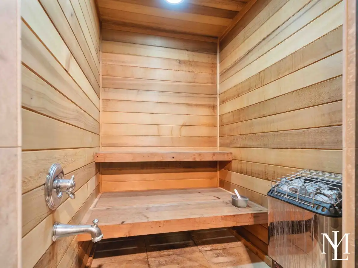 Built-in wood sauna with warm cedar interior in private wellness suite of luxury Huntsville, Utah home.