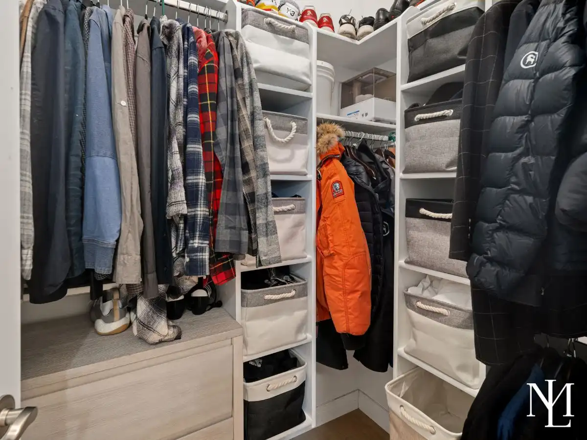 Walk-in closet with custom shelving and built-in storage in Lakeside Village condo.