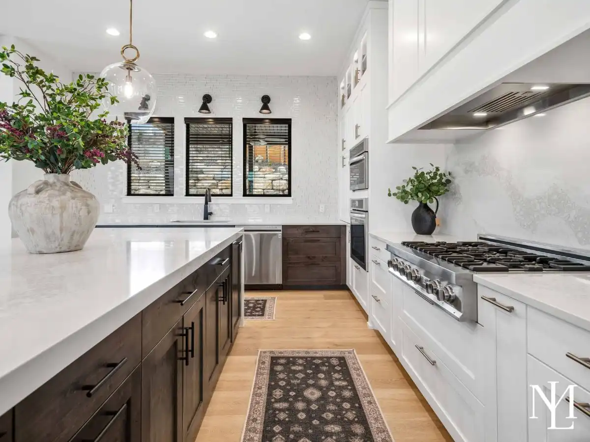 Gourmet kitchen with large quartz island, custom cabinetry, and stainless steel range.