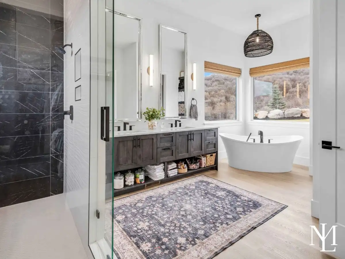 Luxury primary bathroom with freestanding tub, dual vanity, and walk-in shower.