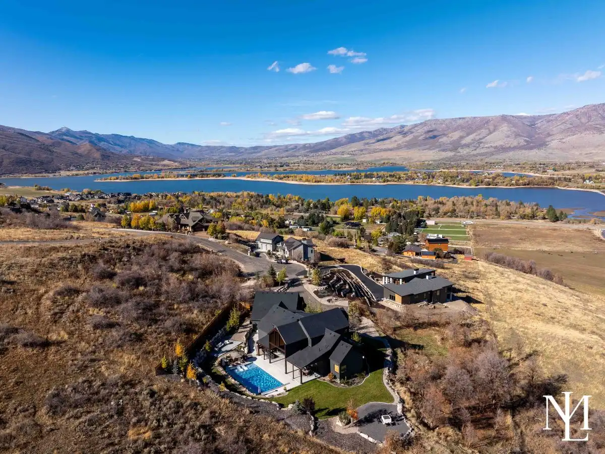 Aerial view of luxury home above Pineview Reservoir with mountain and valley views.