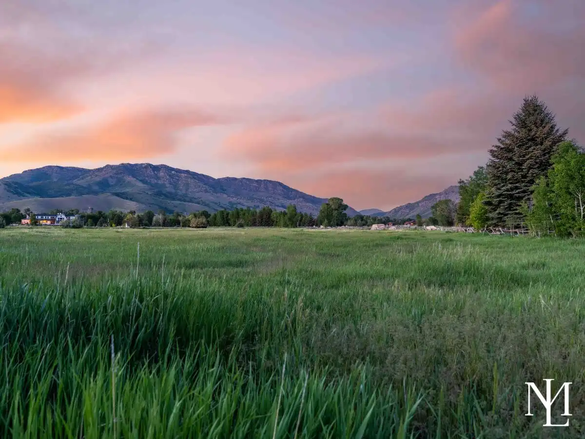 Twilight over open land with mountain ridge and meadow in Ogden Valley, UT.