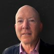Patrick Carrol professional headshot for Mountain Luxury Real Estate against a dark background