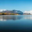 Pineview Reservoir in fall set against a snow capped Snowbasin Resort and mountainscape.