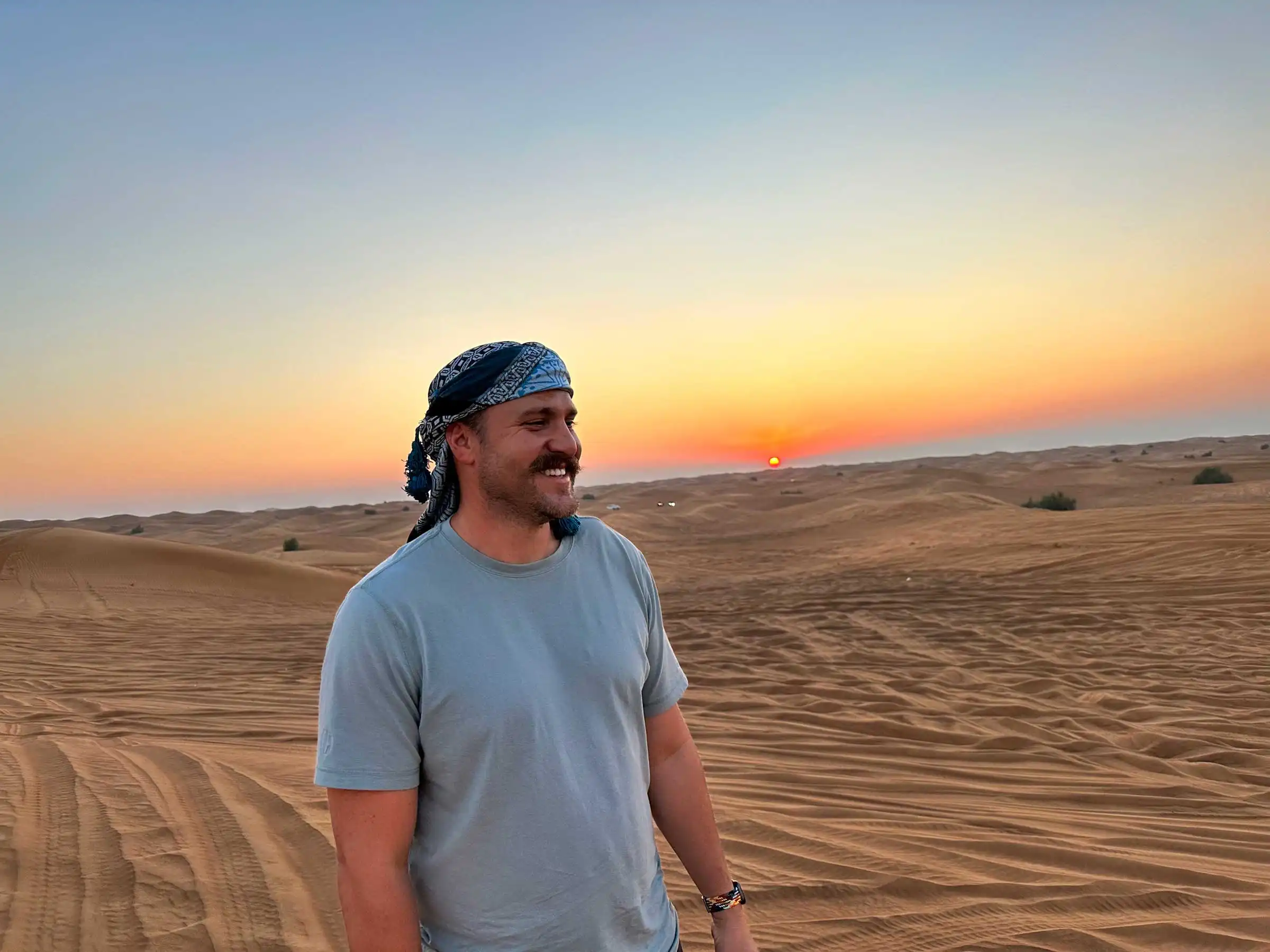 Adam Stuart standing in the desert at dusk.