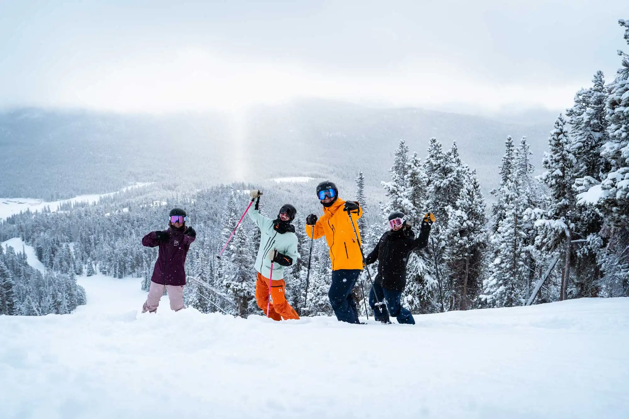 Skiers celebrating a powder day at Eldora Ski Resort in Nederland, Colorado, surrounded by snow-covered pines and Rocky Mountain views.
