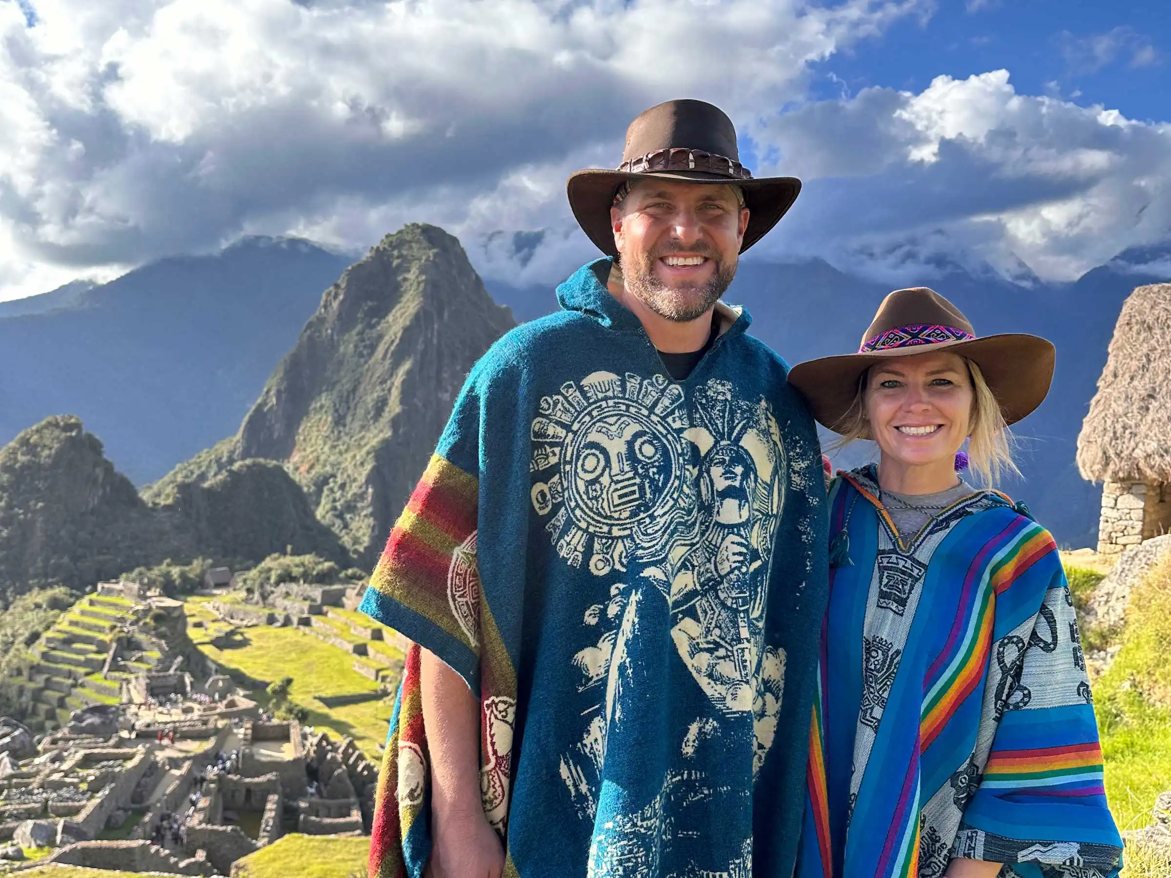 A couple standing in front of Machu Picchu.
