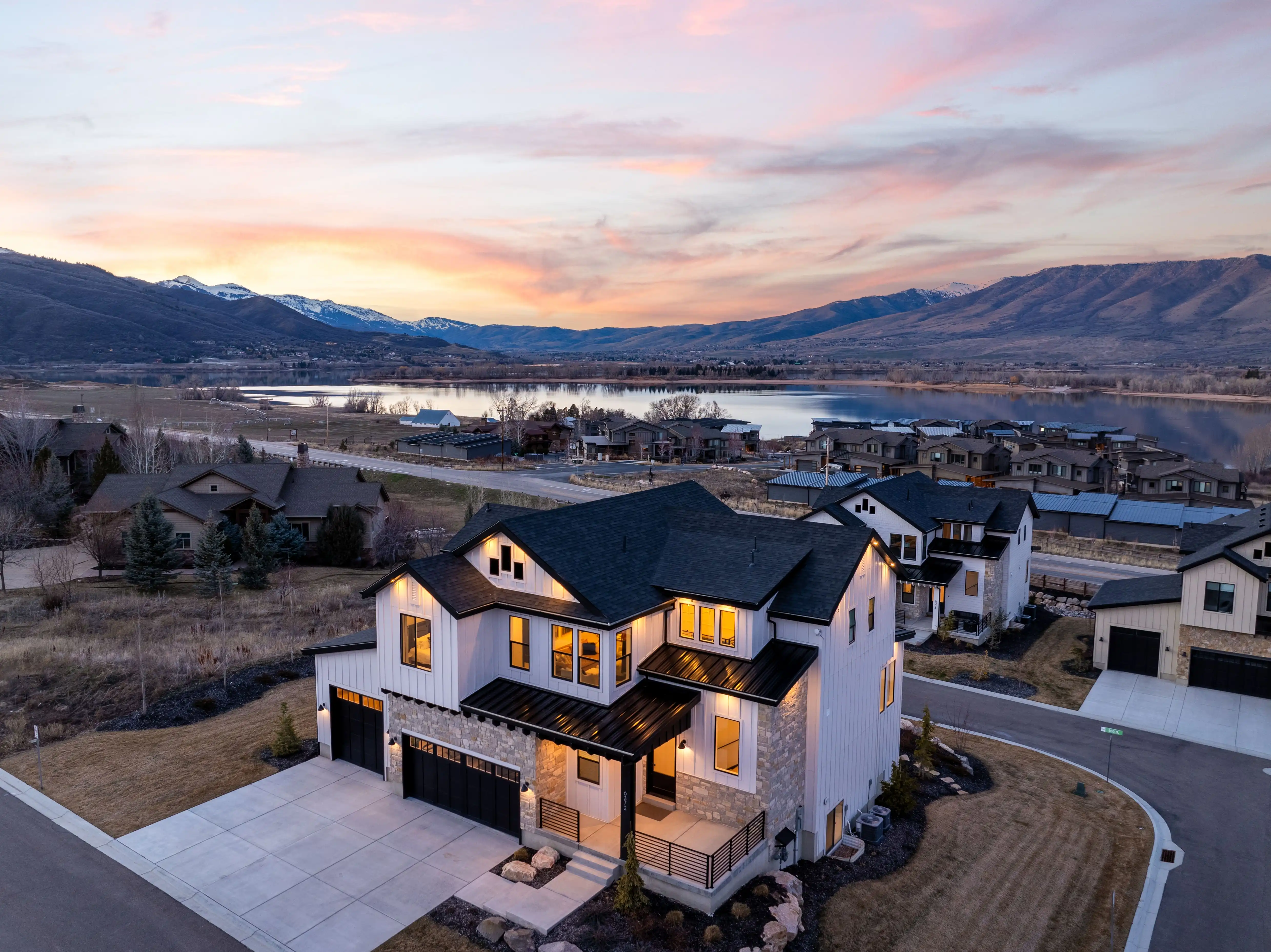 6372 E 950 S #6 Huntsville, UT 84317 basking in the glow of the sunset with a mountain lake in the background.