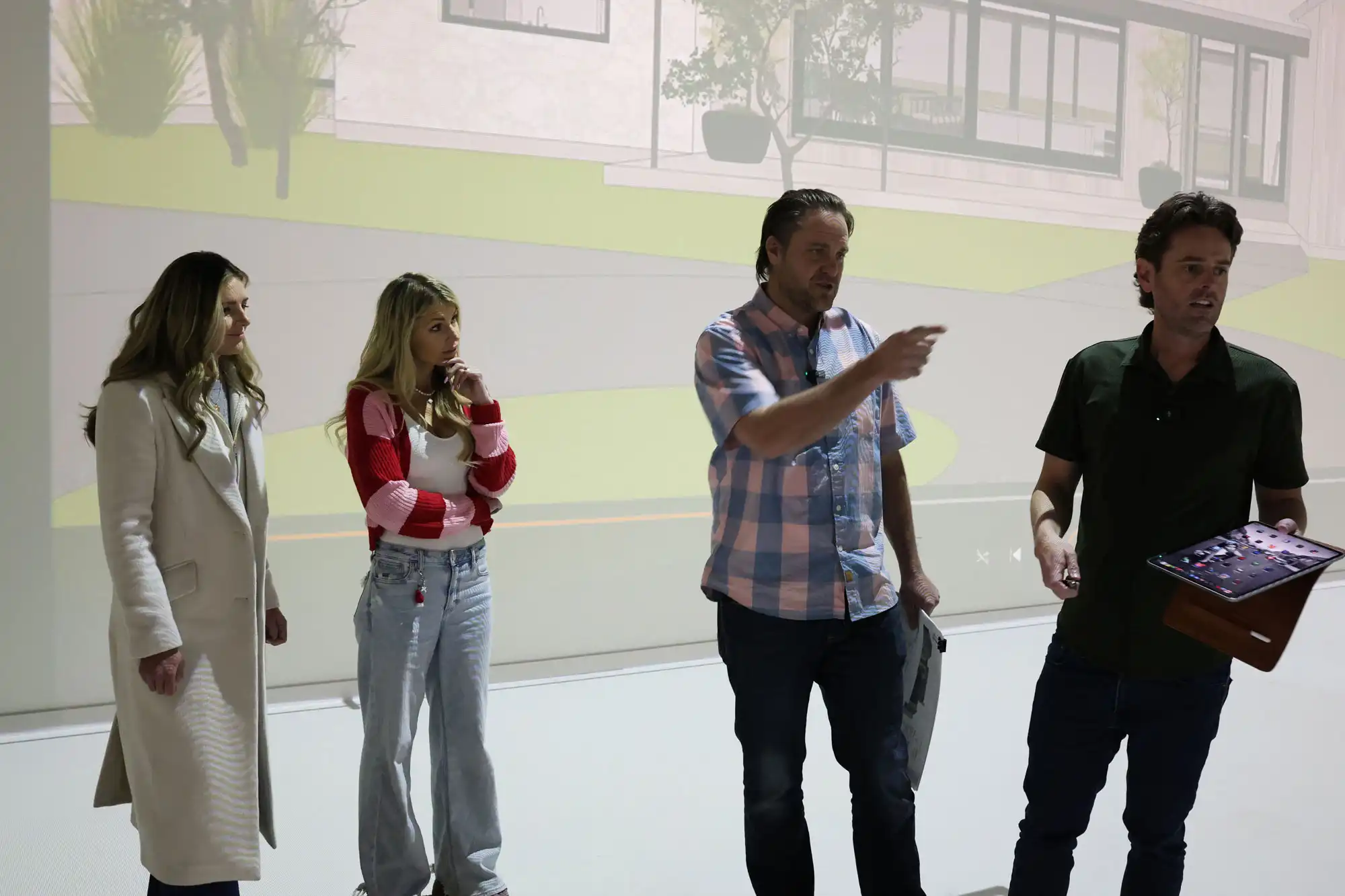 Homeowners and design team reviewing a custom home rendering during an architectural walkthrough