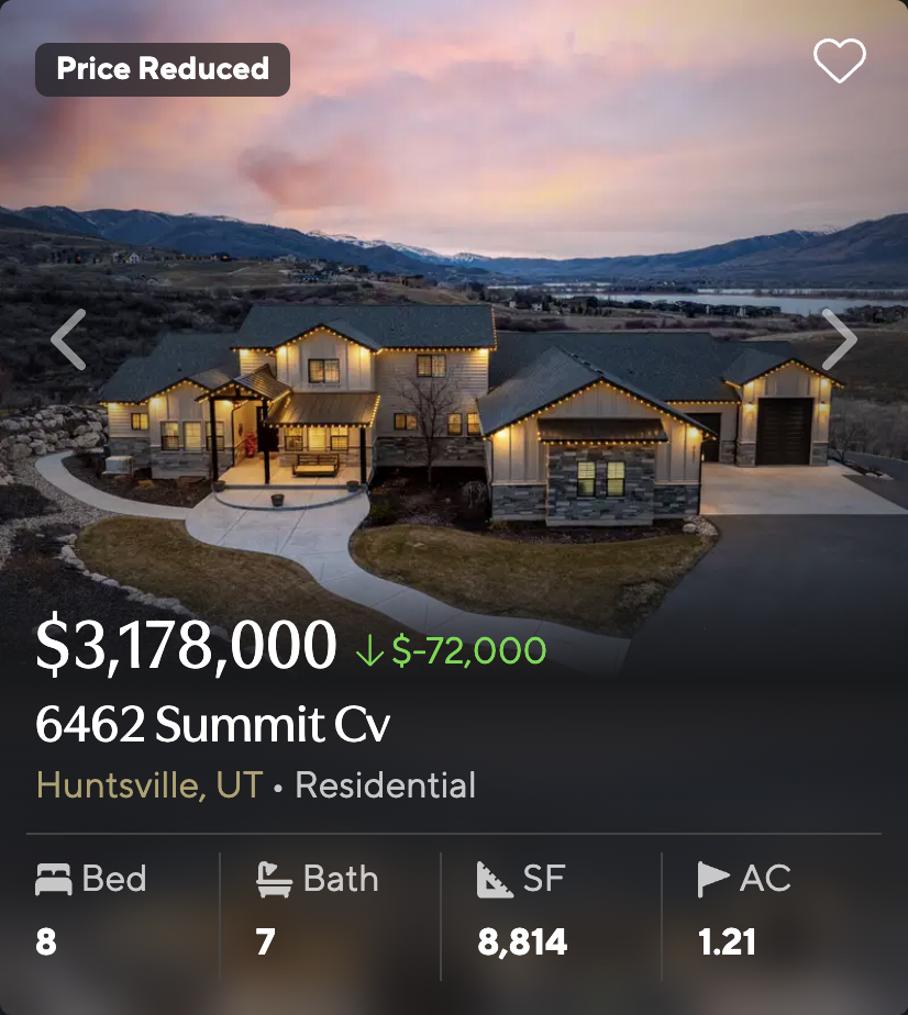 Craftsman-style home at 6462 Summit Cv in Huntsville, Utah, decorated with string lights at sunset with mountain backdrop