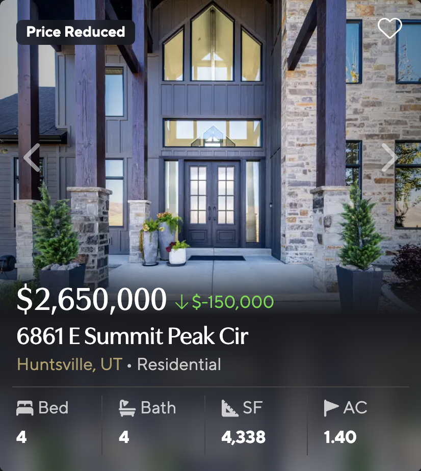 Stone and timber entryway of home at 6861 E Summit Peak Cir in Huntsville, Utah, with double glass doors
