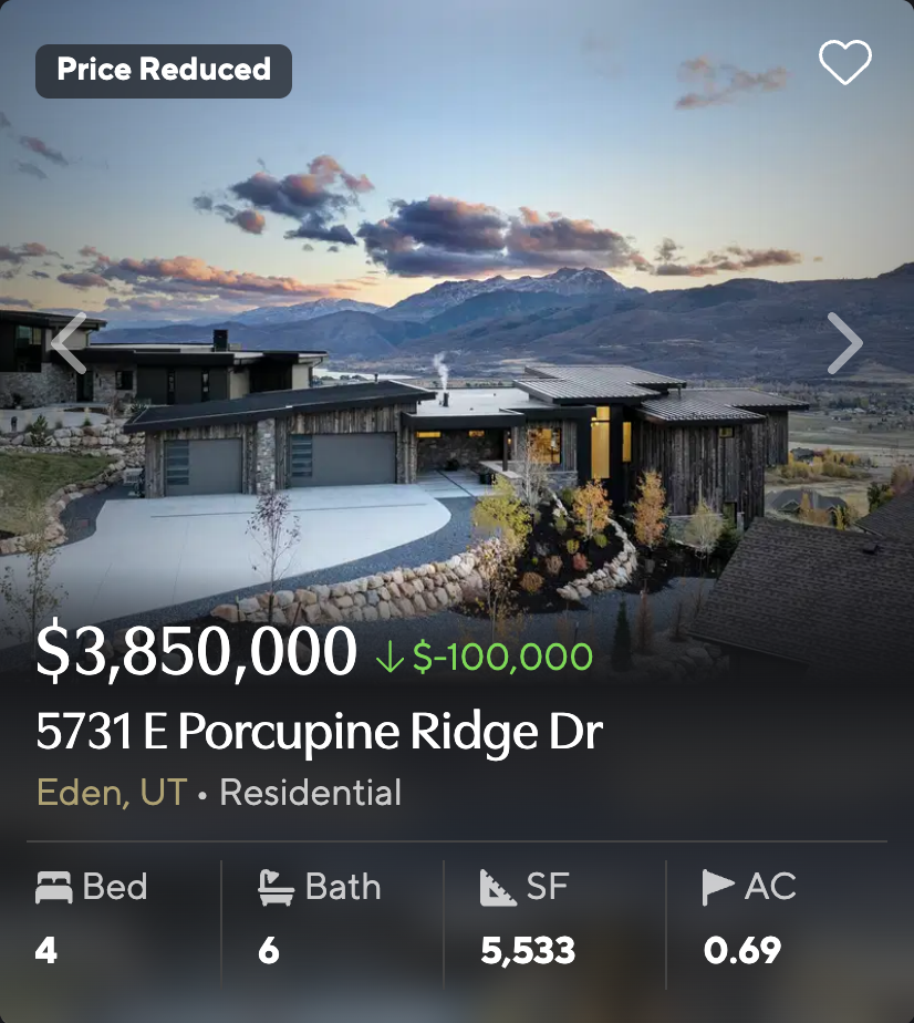 Modern mountain home at 5731 E Porcupine Ridge Dr in Eden, Utah, with dark wood siding and valley views at dusk