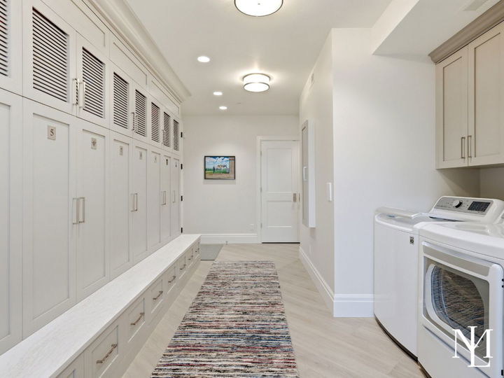 Oversized laundry and mudroom with custom lockers, bench seating, and built-in storage in luxury Huntsville home.