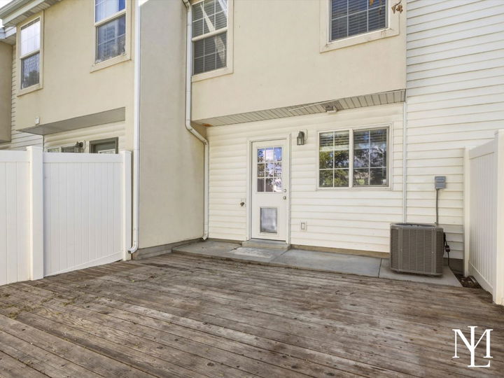 Private fenced patio at Draper townhome with wood deck, exterior access, and outdoor living space
