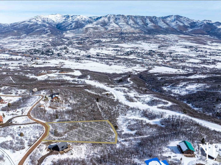 Aerial view of Eden Utah land for sale with outlined homesite, snow-covered Ogden Valley, and mountain views
