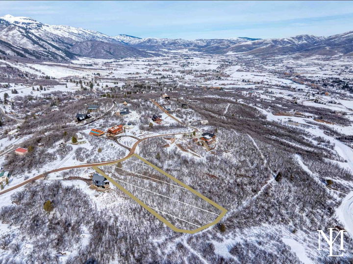 Aerial view of wooded lot in Eden Utah with panoramic Ogden Valley, mountain, and Pineview Reservoir views
