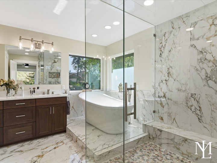 Spa-like primary bathroom with marble shower, soaking tub, and modern vanity in luxury Layton Utah home.