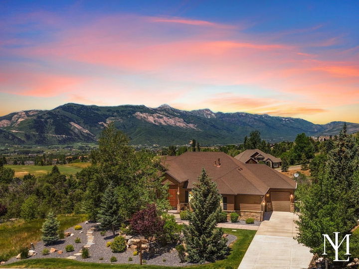 Custom Elkhorn hillside home in Eden Utah with panoramic Ogden Valley mountain views and sunset sky