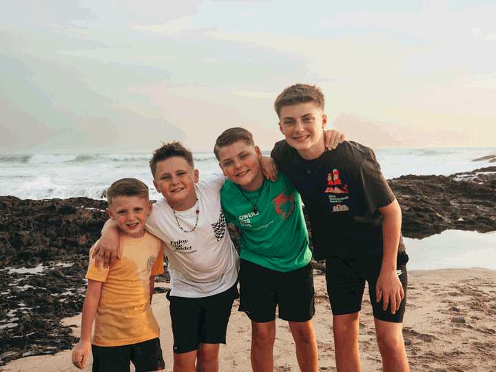 Four boys on the beach.