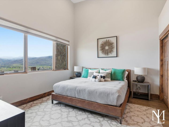 Primary bedroom with large picture window and Ogden Valley mountain views