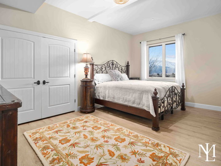 Bedroom with rustic accents, and rug with orange flowers and leaves