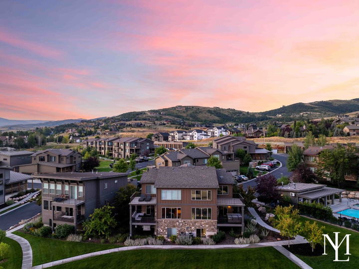Aerial view of the Edgewater townhome community with landscaped grounds, neighboring homes, and hillside views.