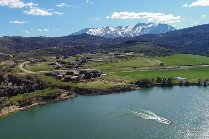 A Boat Headed away from Edgewater with Snowbasin in the Background