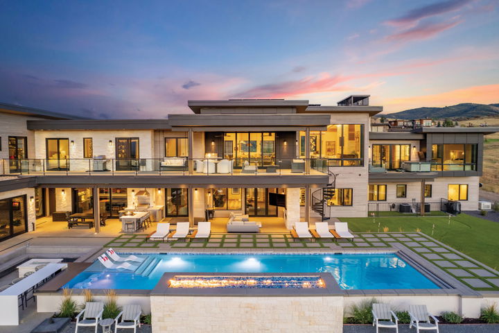 A beautifully designed home by Bertoldi Architects with a pool, lit poolside fire pit and double deck.