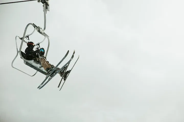 Skiers on a lift.